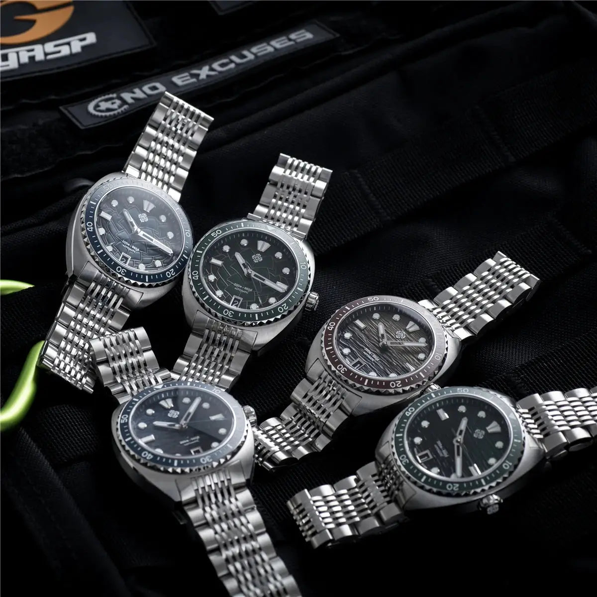 Six IXDAO IPOSE 2026 men's automatic diving watches with Poseidon pattern dials and stainless steel bracelets