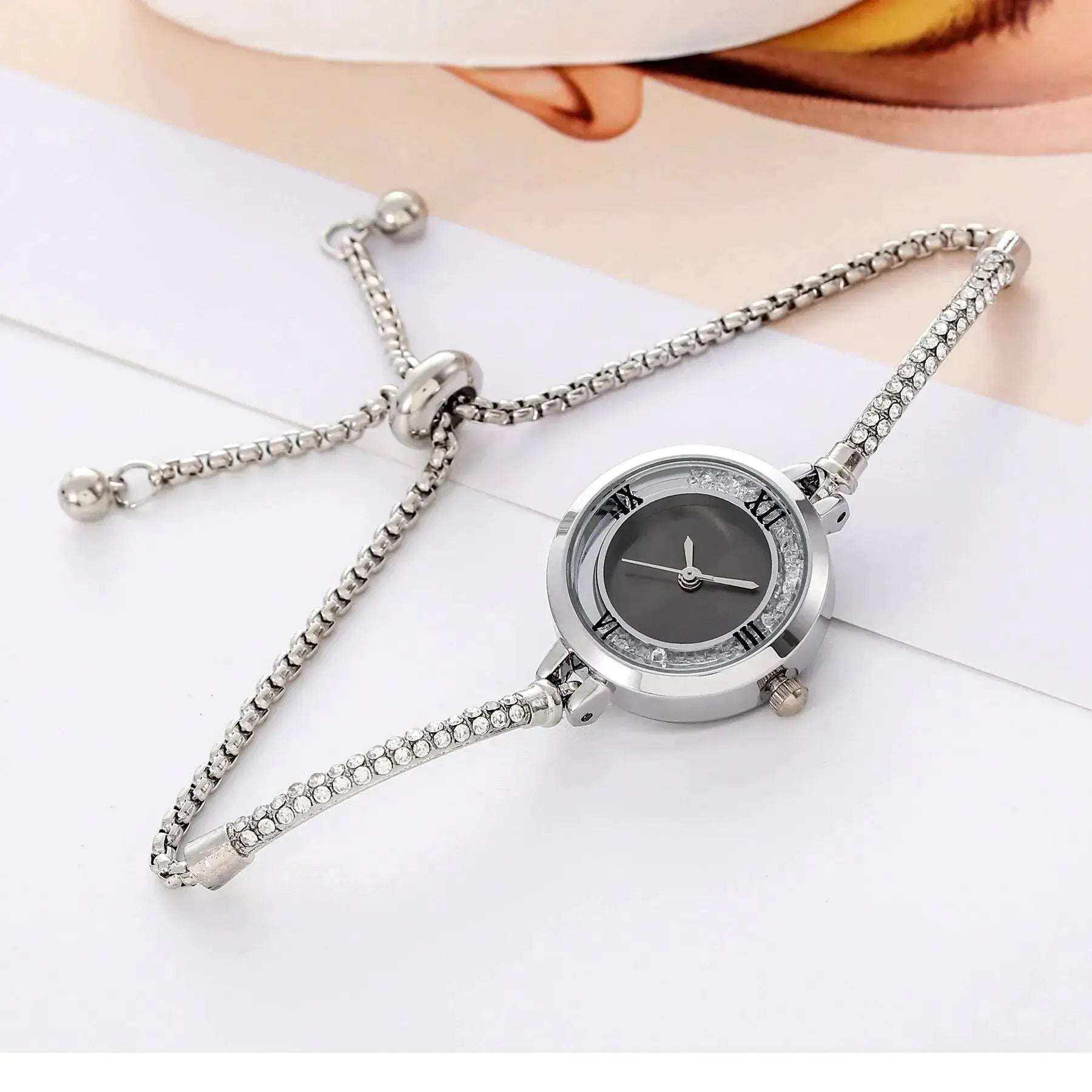 Simples Market women's wristwatch; silver-tone steel bracelet with crystals and a round dial.