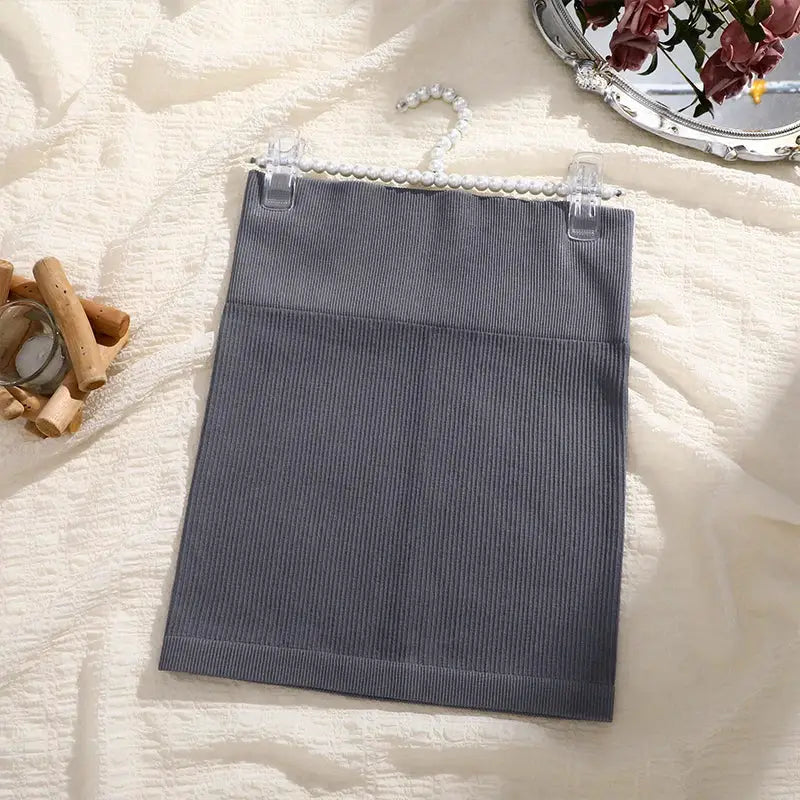 Women's high-waist ribbed knit mini skirt in gray, suitable for professional workwear.