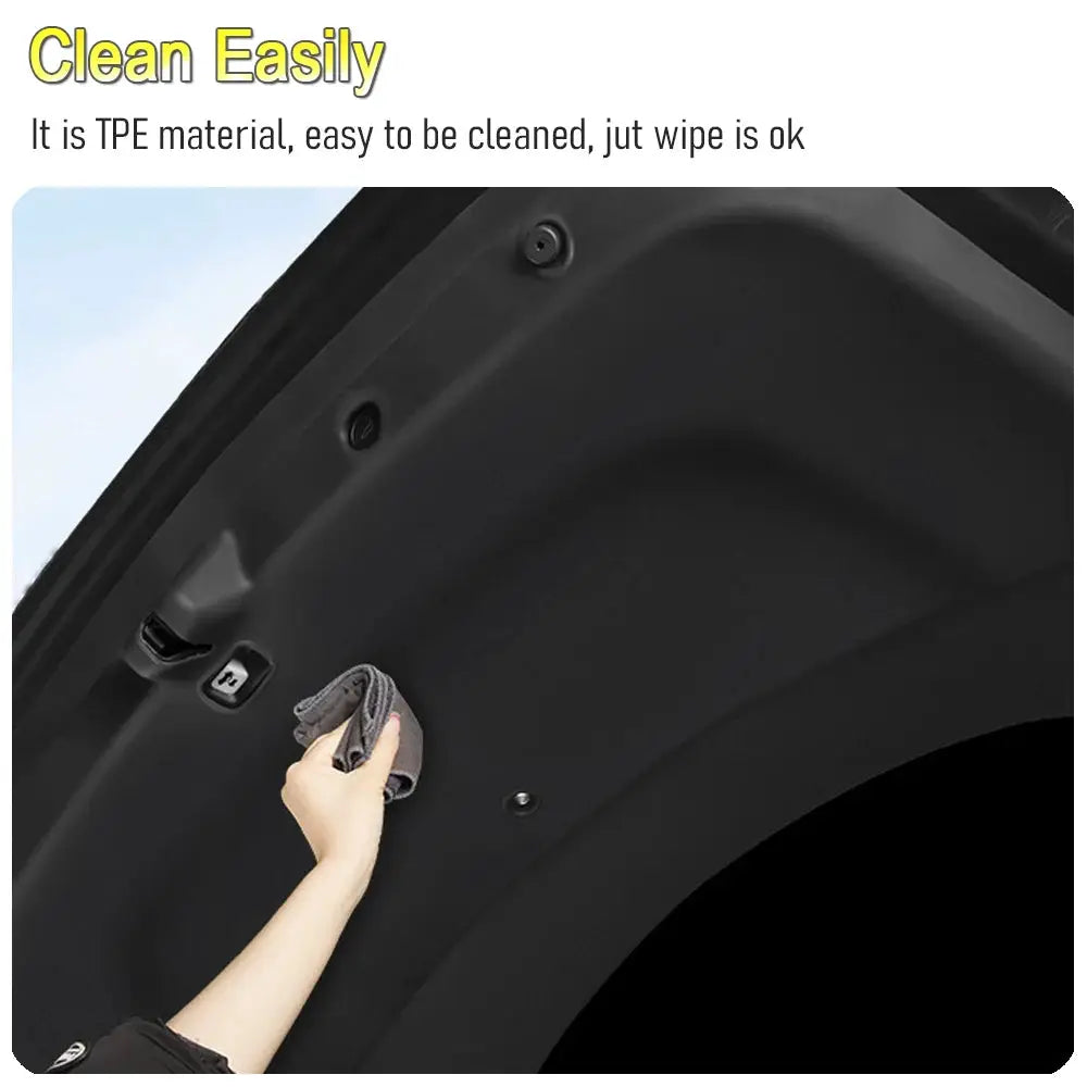 Black trunk mats for Tesla Model Y Juniper 2025–2026; rear tailgate protective mat being wiped clean