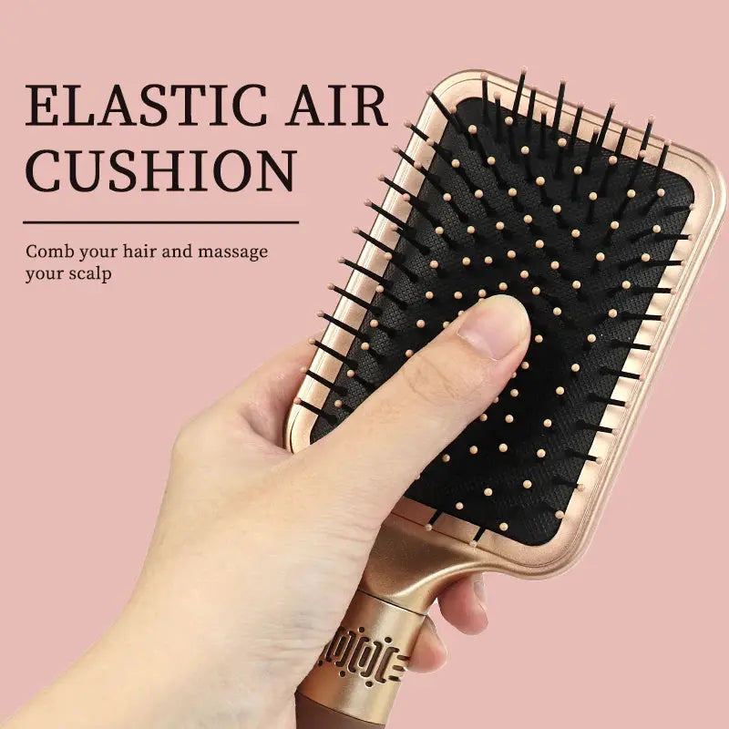 Hair brush Simples Market detangler with elastic air cushion, rose-gold handle and black cushion.