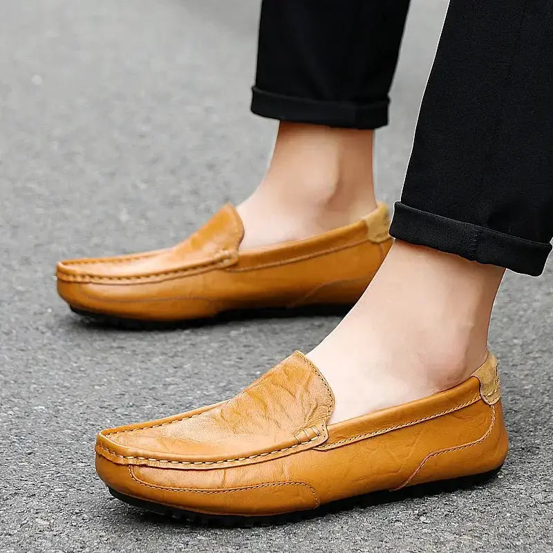 Pair of men's tan genuine leather loafers slip-on moccasins with stitched detailing