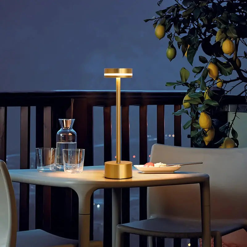 Touch small night light LED aluminum desk lamp by Simples Market, gold-tone with adjustable brightness on a dining table