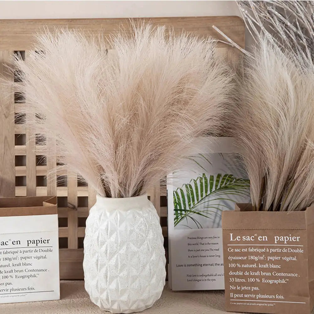 Simples Market pampas grass decor in a white textured vase; two beige fluffy bundles