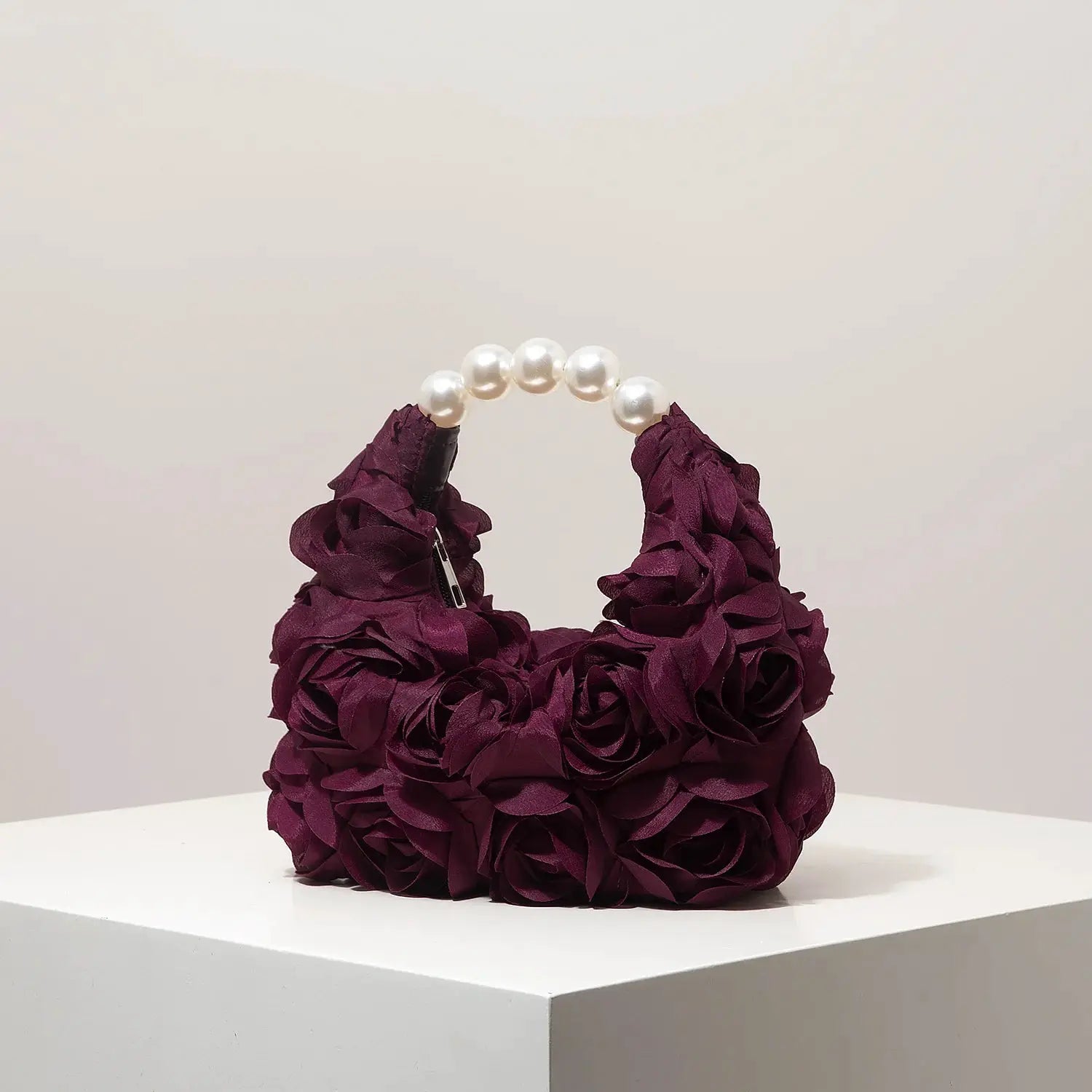 Purple floral rosette handbag with a pearl bead handle, elegant gala clutch