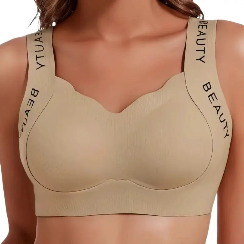 Ribbed wireless seamless bra in nude beige with wave neckline and wide straps featuring BEAUTY branding, plus size.