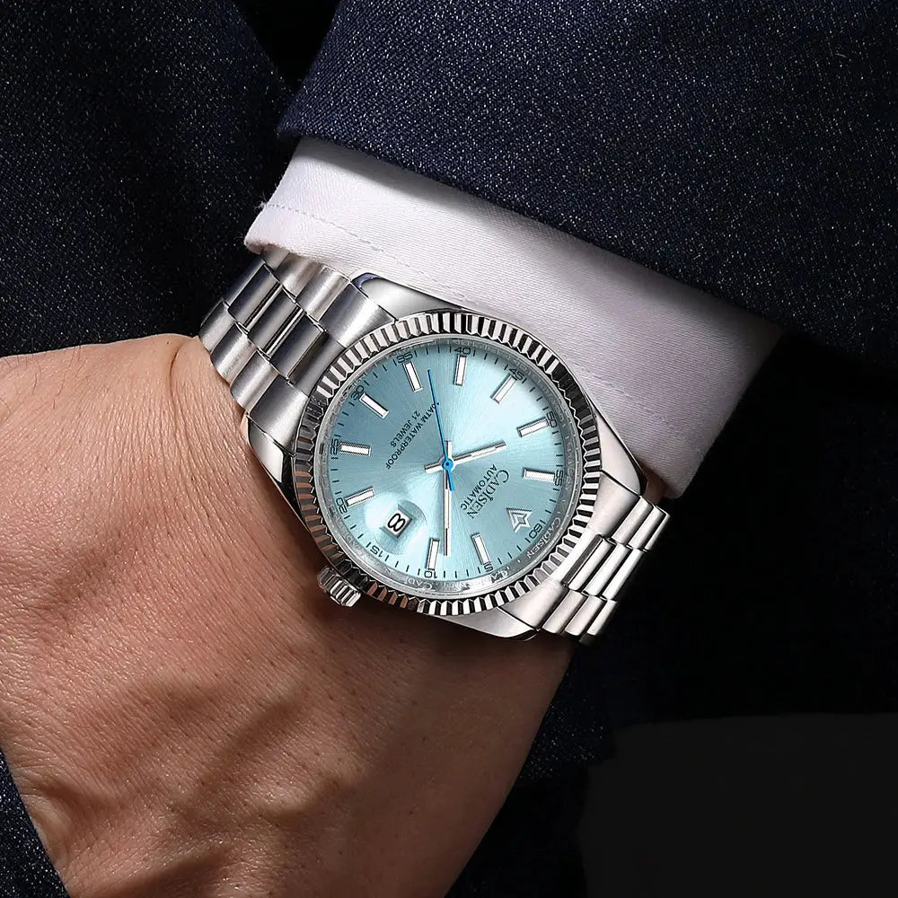 CADISEN men's mechanical automatic watch with blue dial, stainless steel bracelet, date window.