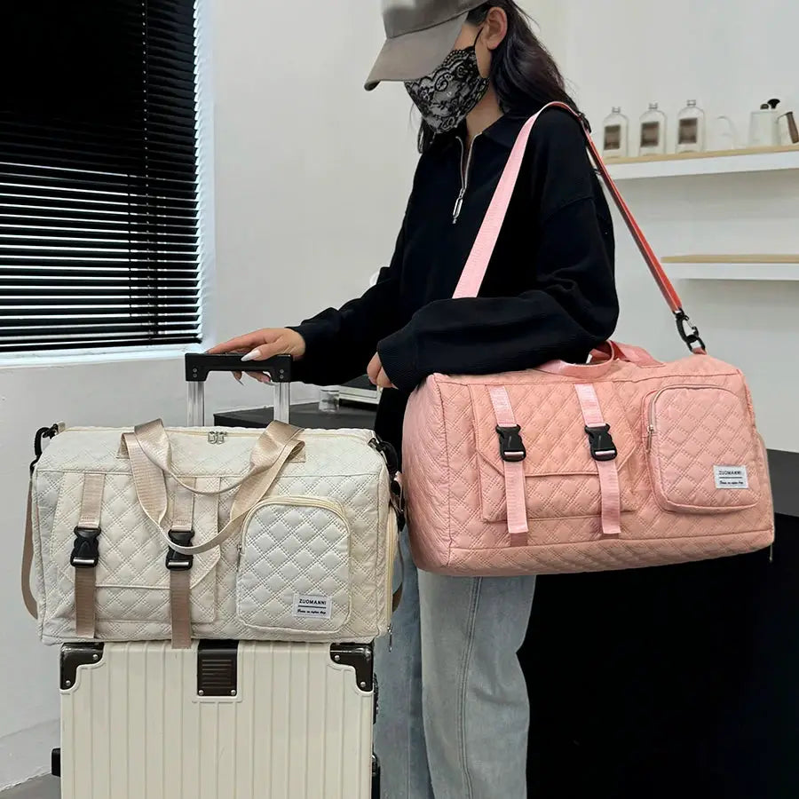 Two durable nylon travel duffle bags in beige and pink by Simples Market with quilted fronts.