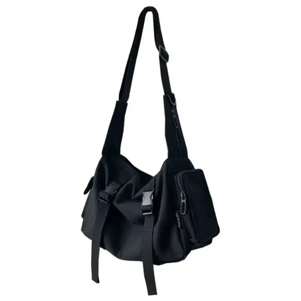 Canvas crossbody bag in black with multiple zip pockets and adjustable strap