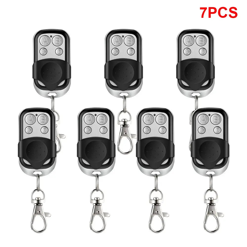 Universal 4-button garage door remotes, 7 pcs, Simples Market, silver and black keychain units with A/B/C/D buttons