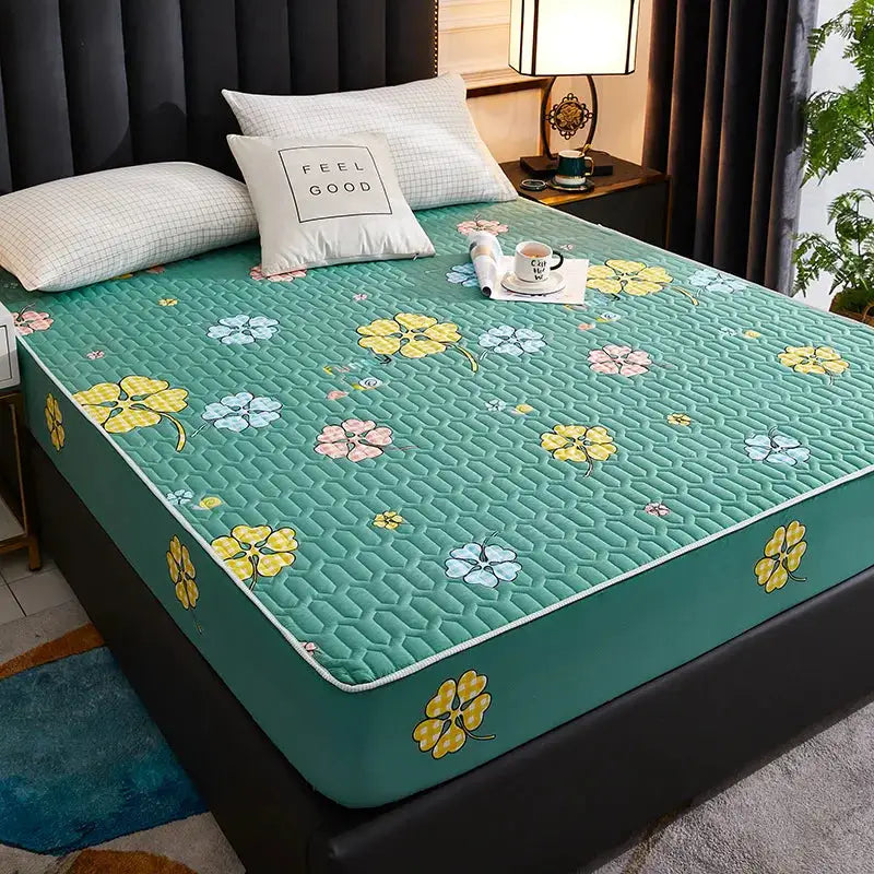 Simples Market waterproof quilted mattress protector in teal with yellow/blue floral pattern