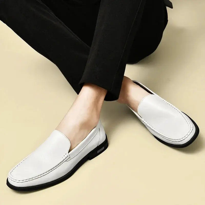 Leather men's slip-on dress loafers, white with black sole and neat stitching.
