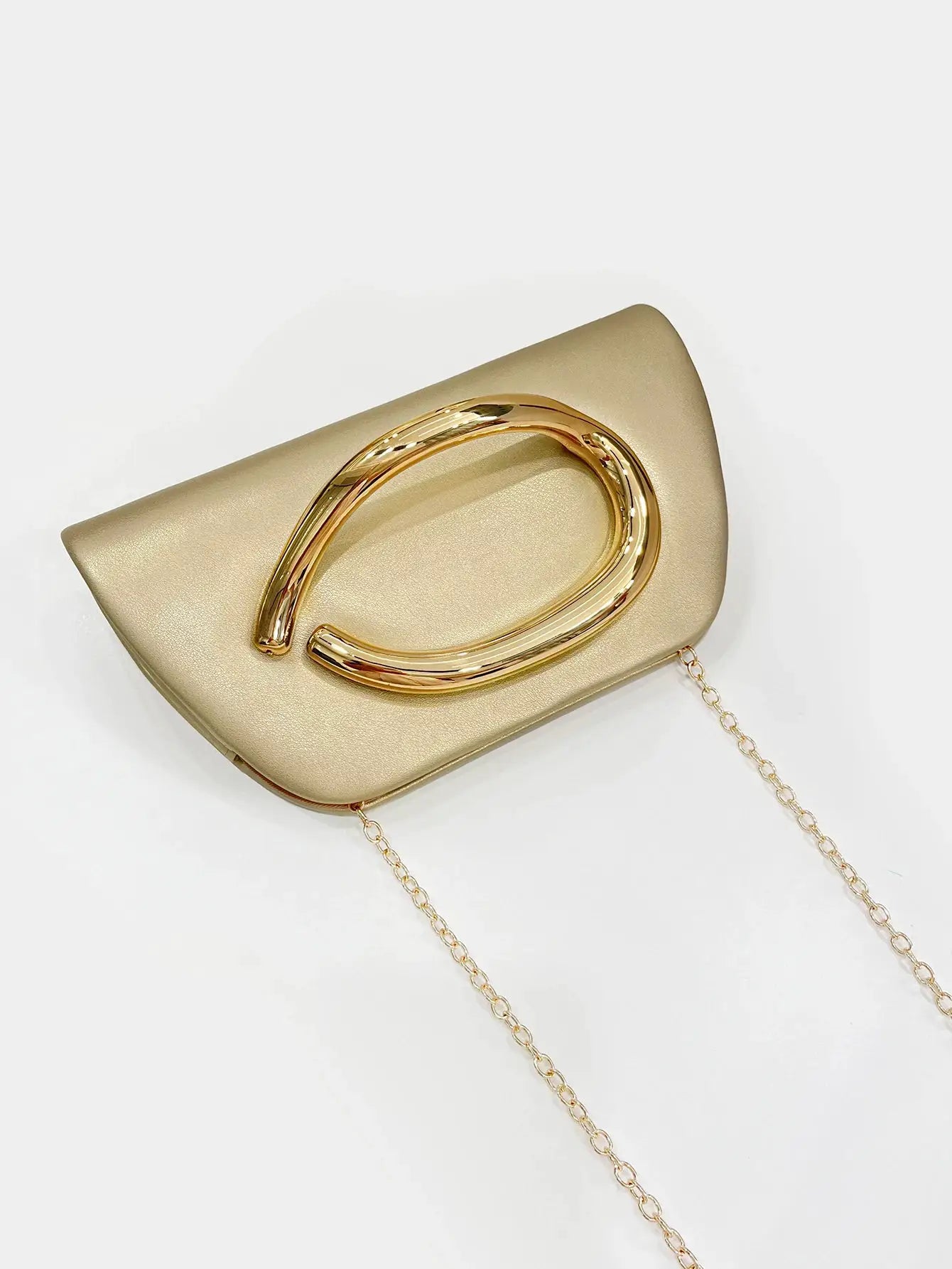 Box clutch in gold-toned metal with a large buckle and chain strap