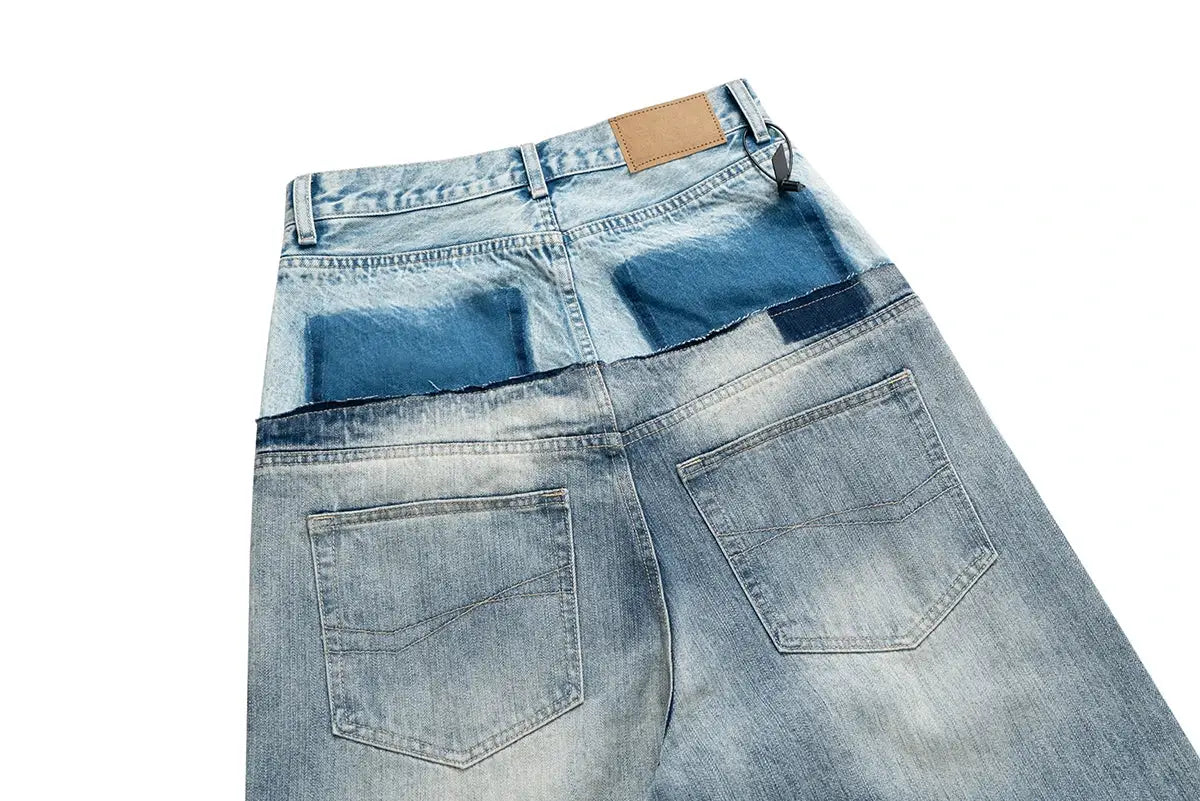 Cut-up patchwork baggy denim jeans with double-waist panels, light-to-mid blue wash, back pockets