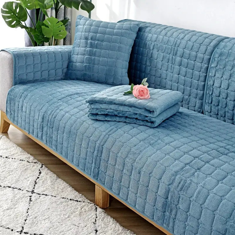 Blue quilted flannel sofa cover set with two matching cushions, non-slip plush seating.