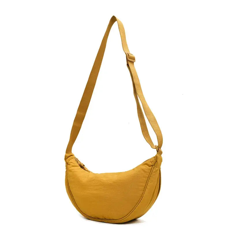 Solid mustard yellow women's crossbody bag with padded nylon and adjustable strap
