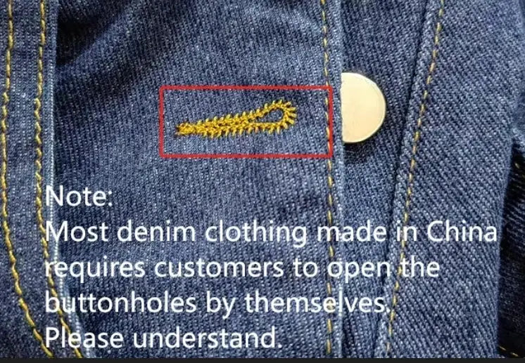 Blue denim shorts fabric close-up with yellow contrast stitching and metal button