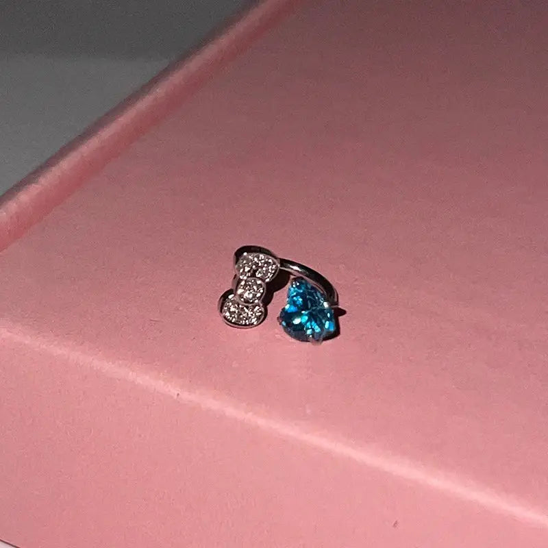 316L stainless steel ear bone ring earring with a bowknot encrusted charm and a blue heart zircon