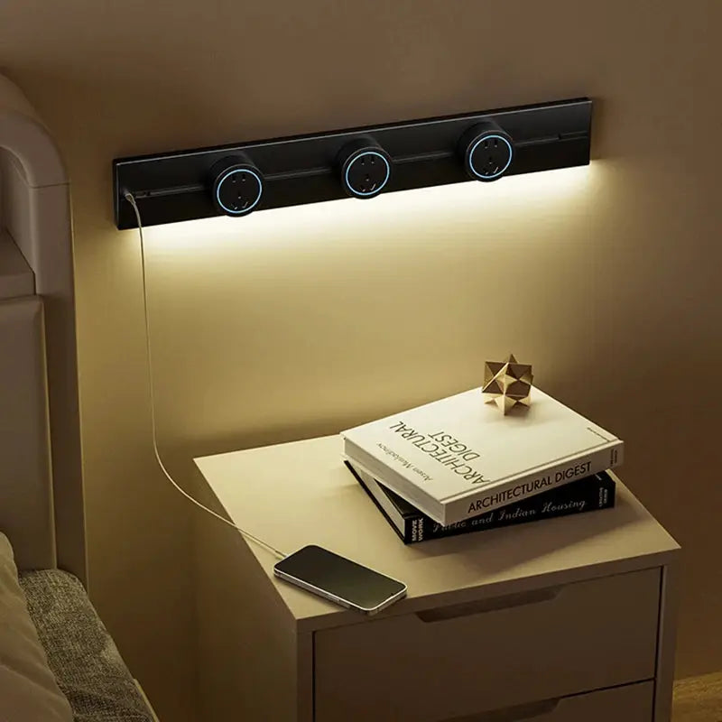 Track socket wall rail with three blue-ring outlets and integrated LED light; black finish, Simples Market.