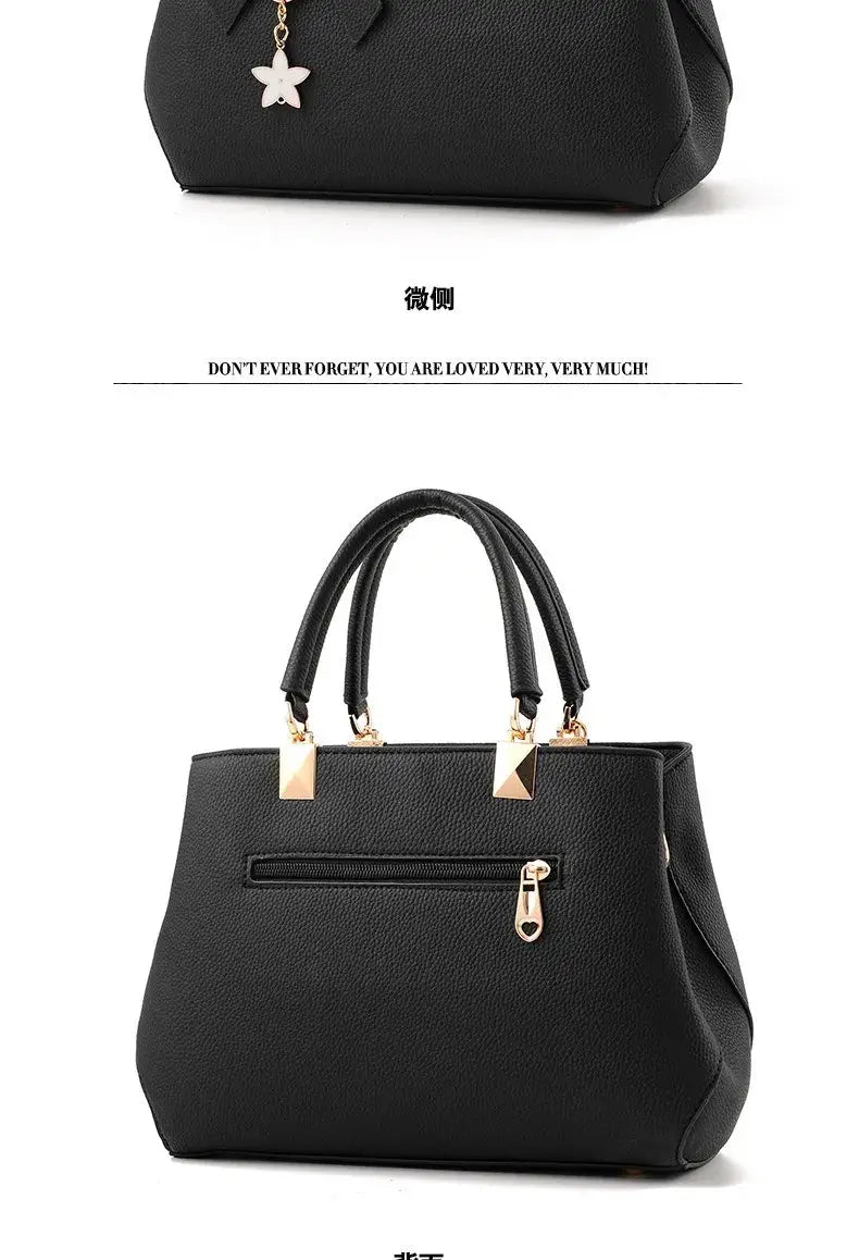 Simples Market black faux leather handbag with double top handles, gold-tone hardware and back zipper pocket.