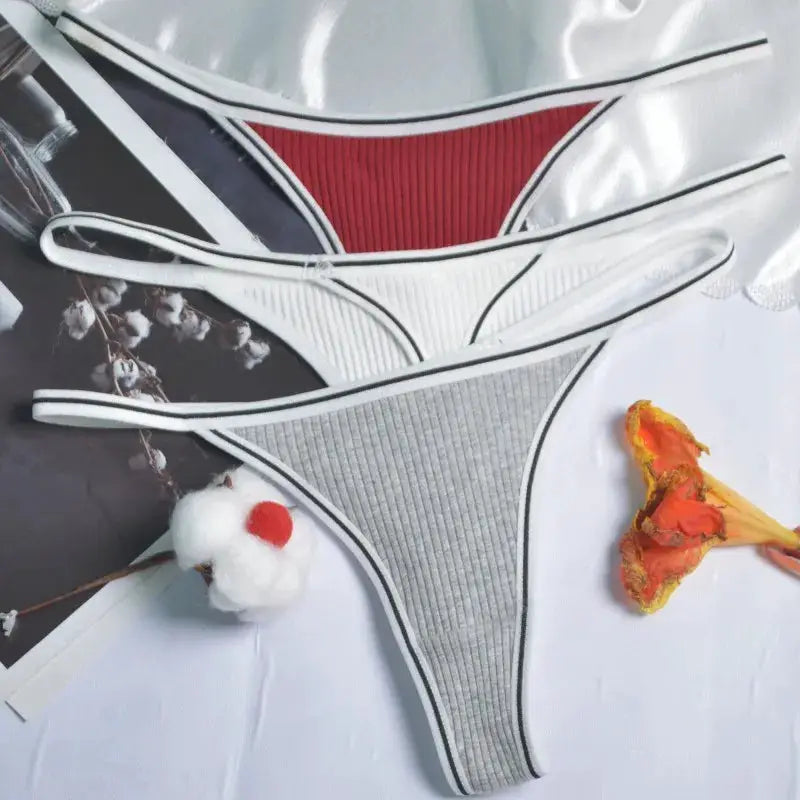 Three-piece ribbed cotton thong set in red, white, and gray; low-rise, seamless G-strings.