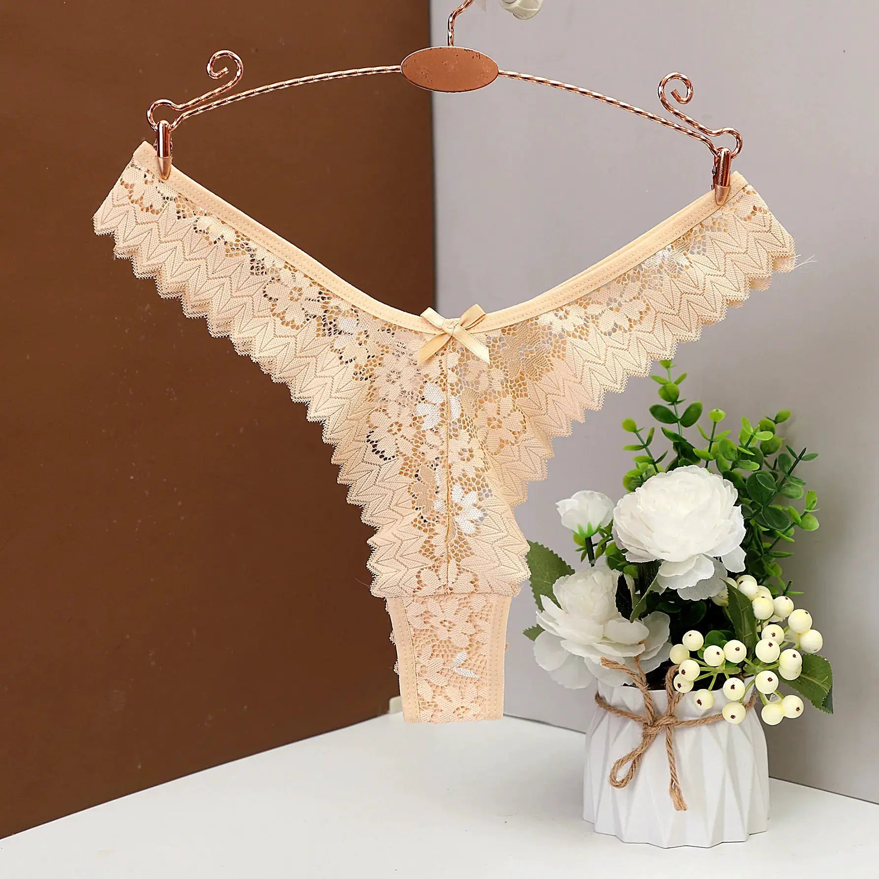 Women's nude beige lace thong; low-rise with floral lace and bow