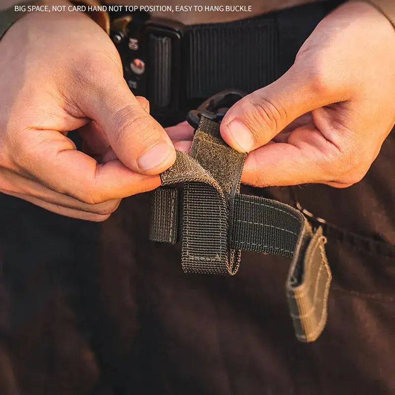 Simples Market nylon work gloves with safety clip; close-up of Velcro strap and hanging buckle on outdoor tactical gear.