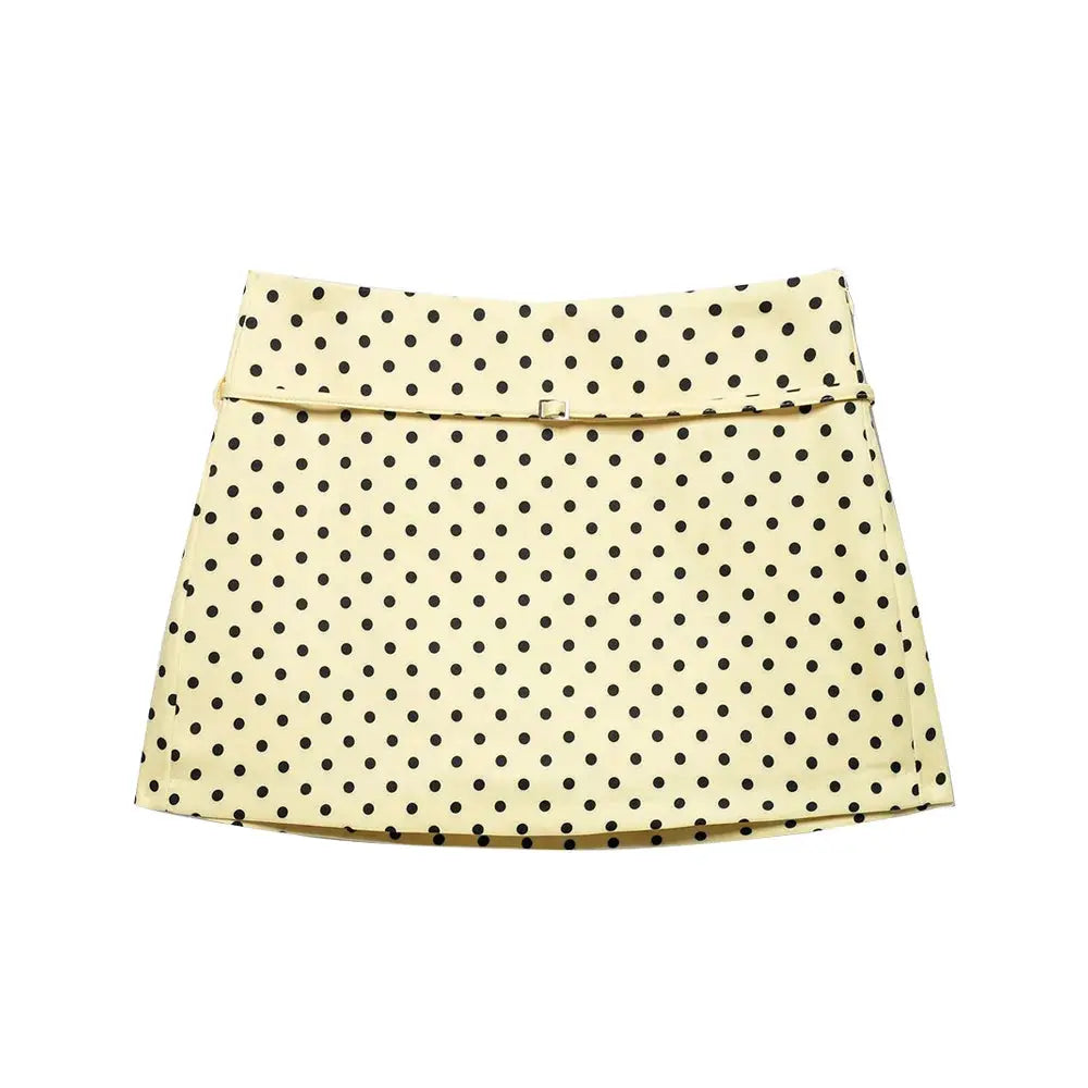 Women's polka dot skort with belt, pale yellow with black spots.