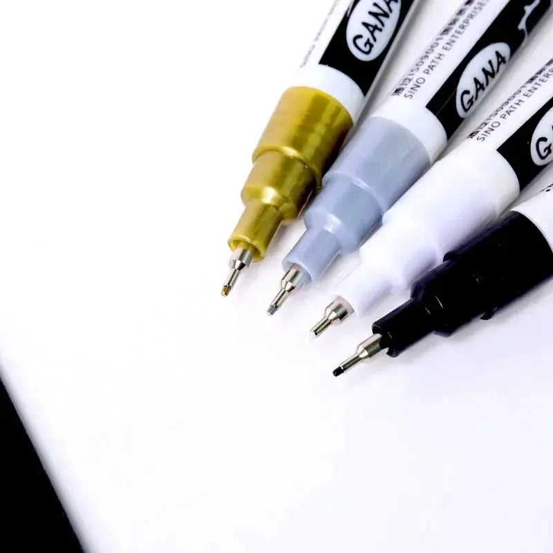 4-pack oil-based permanent paint markers with 0.7mm tips in white and black; waterproof for rock painting, wood, metal, canvas