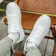 White PU leather sneakers, casual vulcanized-style footwear, two shown.
