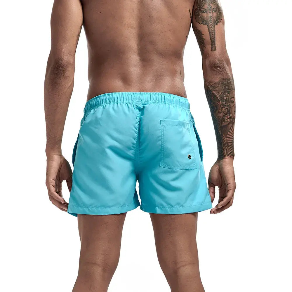 Men's turquoise quick-dry swim trunks with back pocket and elastic waistband