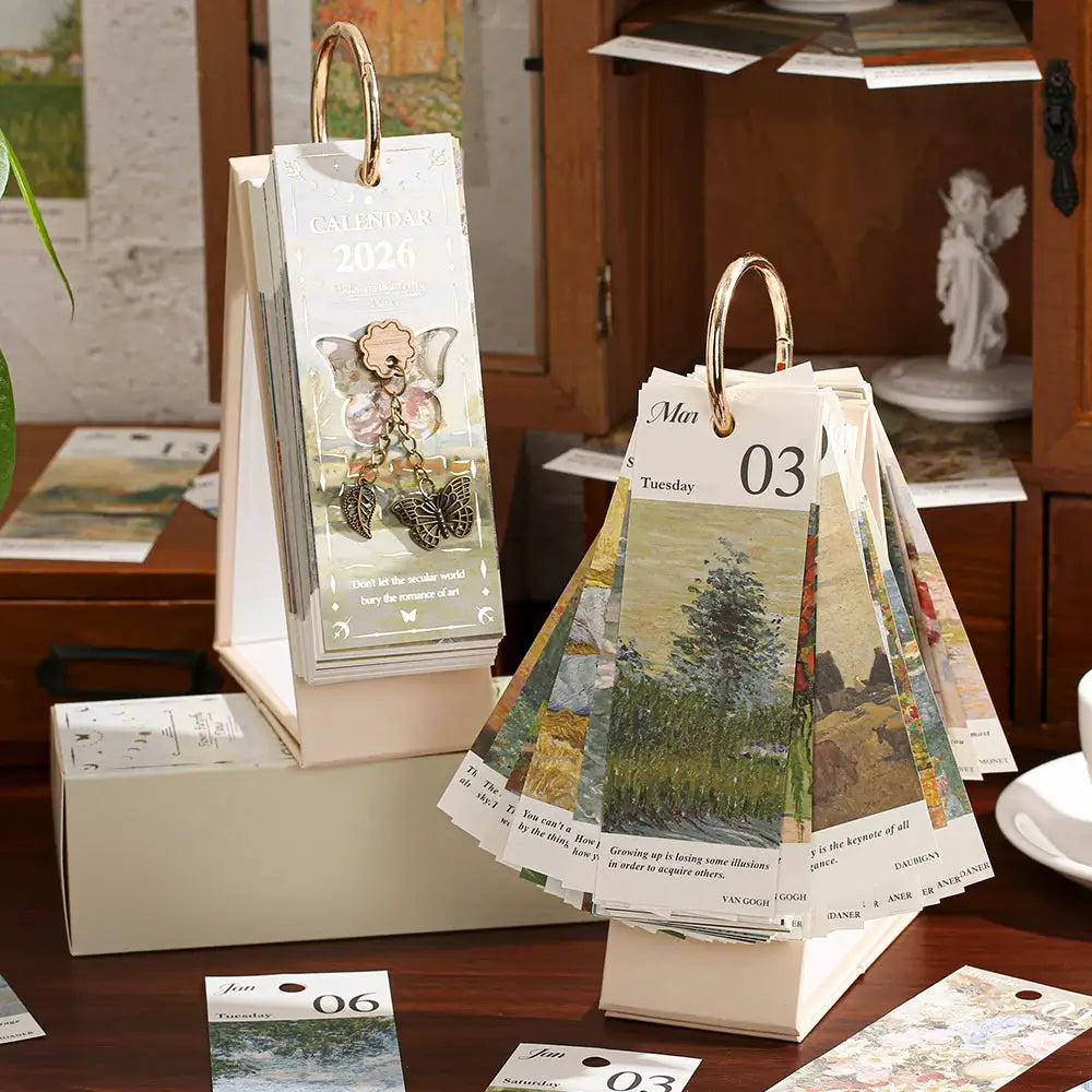 2 Simples Market 2026 desk calendars with gold ring binding, vintage oil painting pages and inspirational quotes