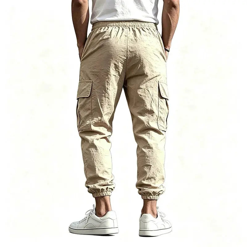 Men's cotton-linen cargo jogger pants by Simples Market in khaki with cargo pockets and elastic cuffs