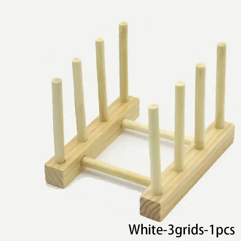 Wooden dish drying rack by Simples Market with vertical pegs and light wood finish