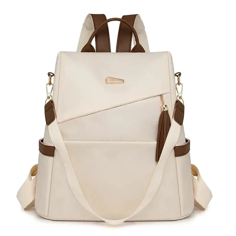Simples Market nylon anti-theft backpack in beige with brown tassel accents, large-capacity travel bag