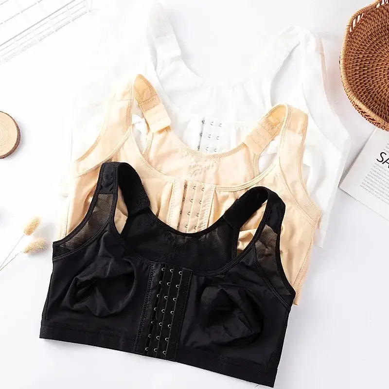 Three large-size front-closure wire-free bralettes in white, beige, and black; unlined, push-up style.