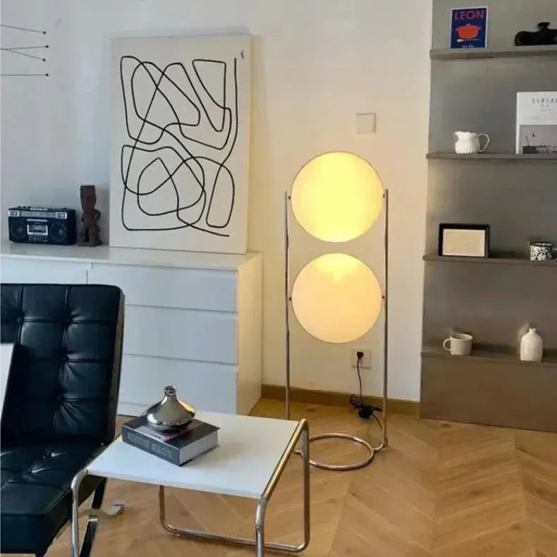 Modern white acrylic circular LED floor lamp with two illuminated discs on a slim metal frame.