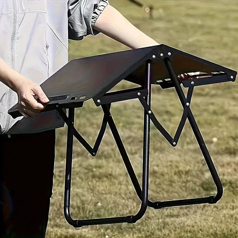 Portable Folding Camping Table by Simples Market, stainless steel outdoor dining table with black foldable frame.