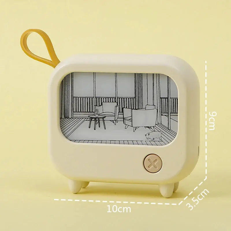 TV-shaped night light, cream with yellow strap, mini desktop lamp showing a line-art room scene.