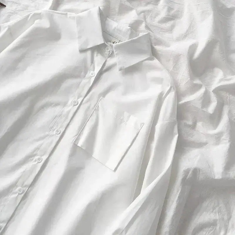 White oversized button-down shirt with front pocket and turn-down collar