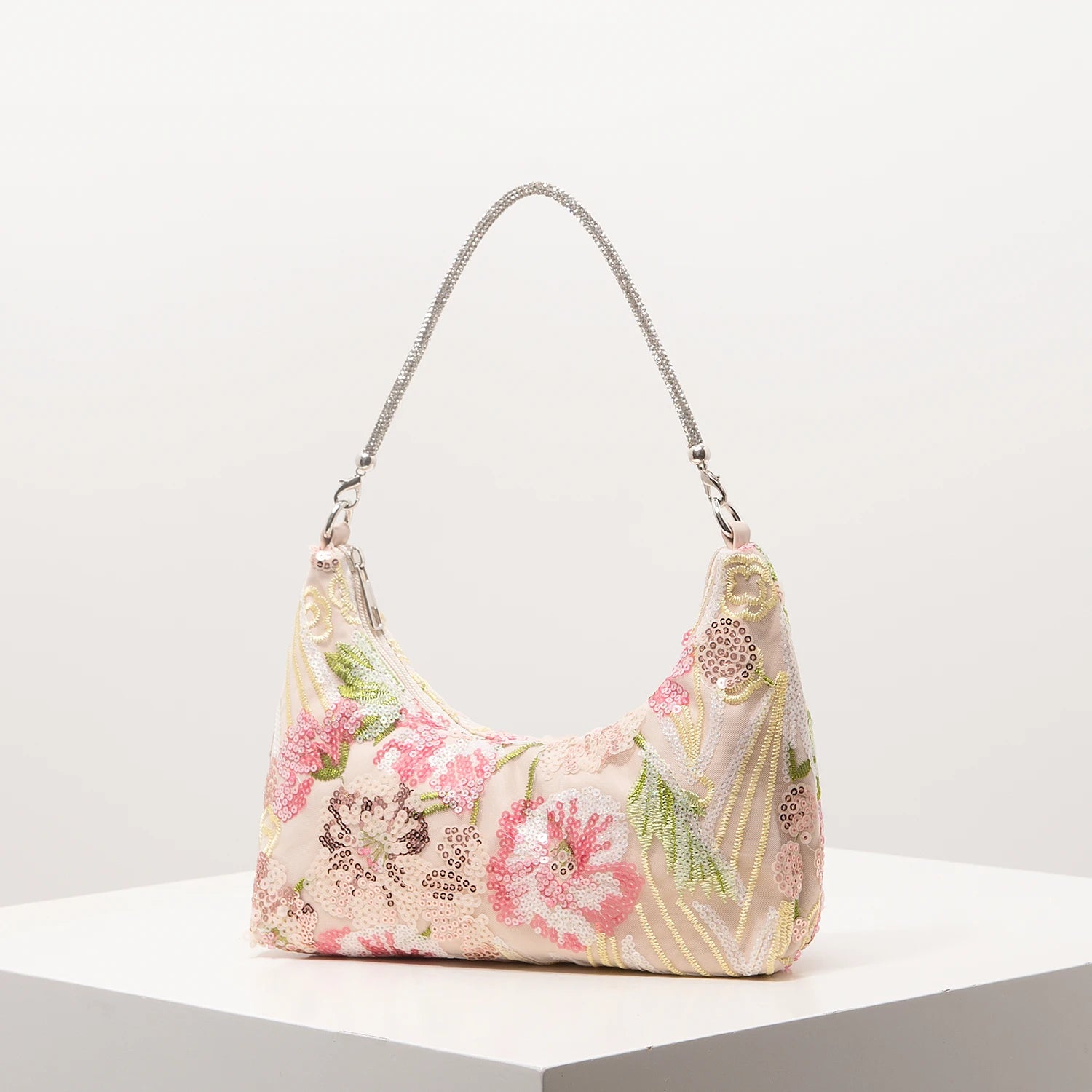 Shoulder bag with pink floral embroidery and sequins on pastel fabric, silver chain strap