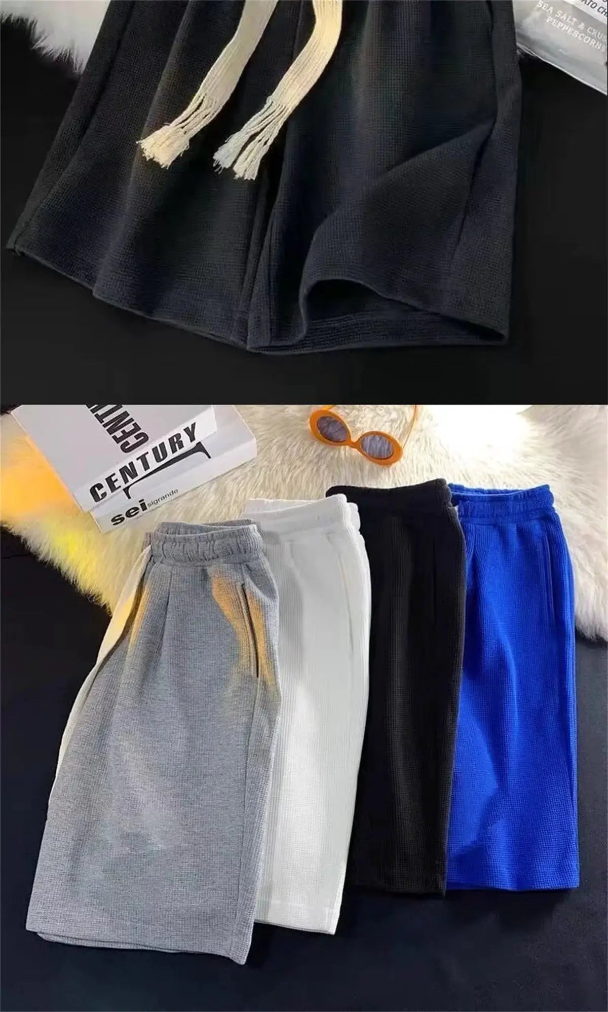 Solid breathable men's shorts in six color options with drawstring waistband; lightweight athletic wear