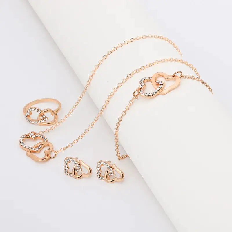 Simples Market Five-piece gold-tone heart-shaped jewelry set for women: ring, earrings, and necklace with rhinestones.
