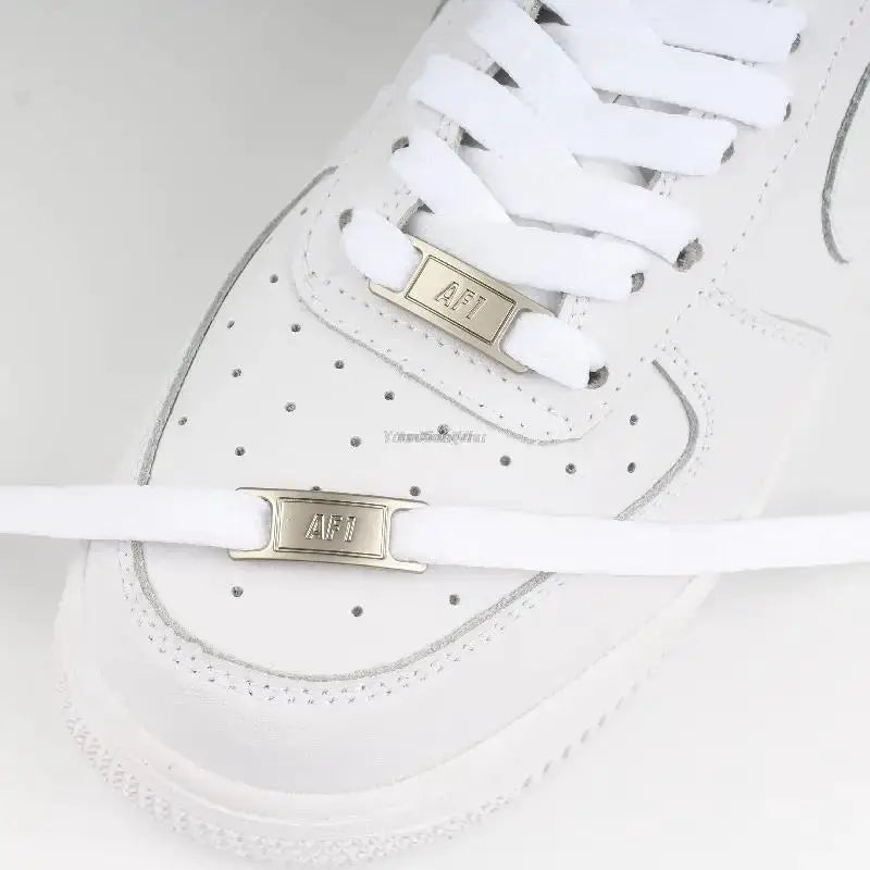 White Air Force 1 sneaker with white flat laces and gold AF1 lace locks