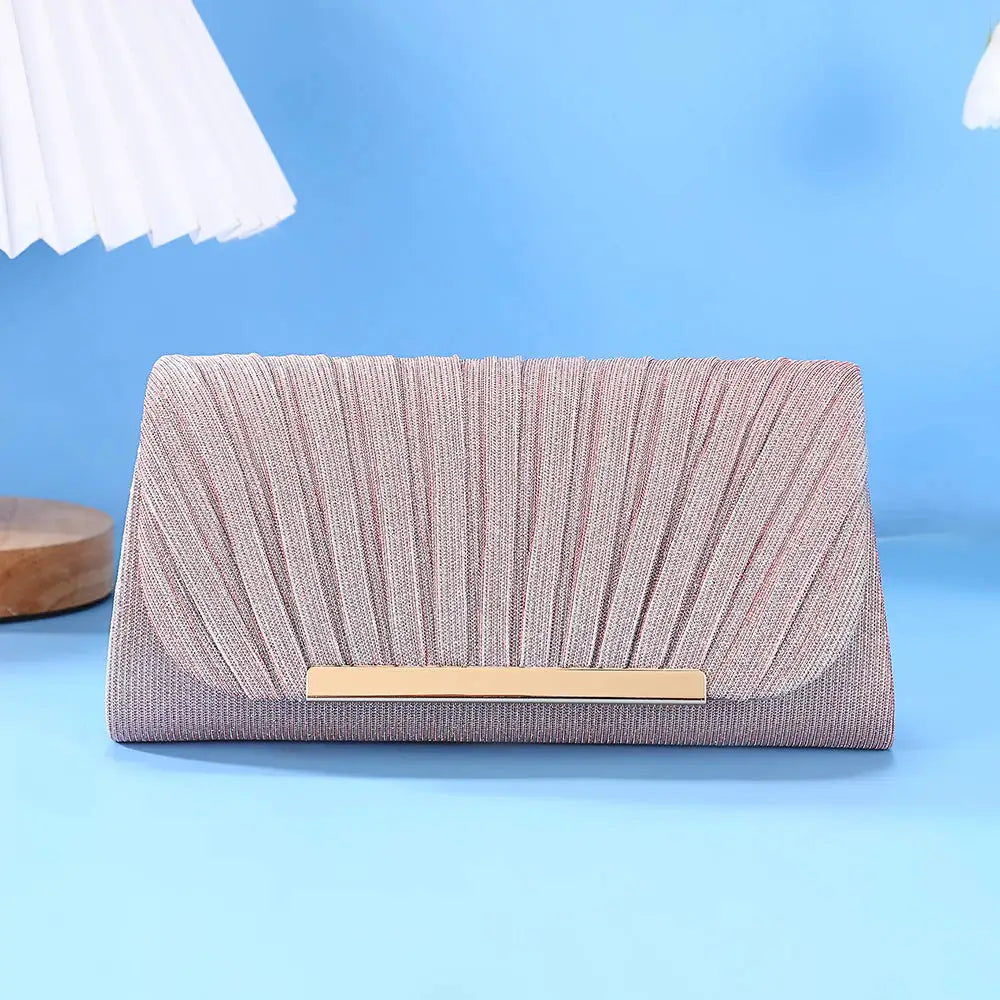 Evening clutch with rose-gold sequins, pleated front and gold bar clasp.