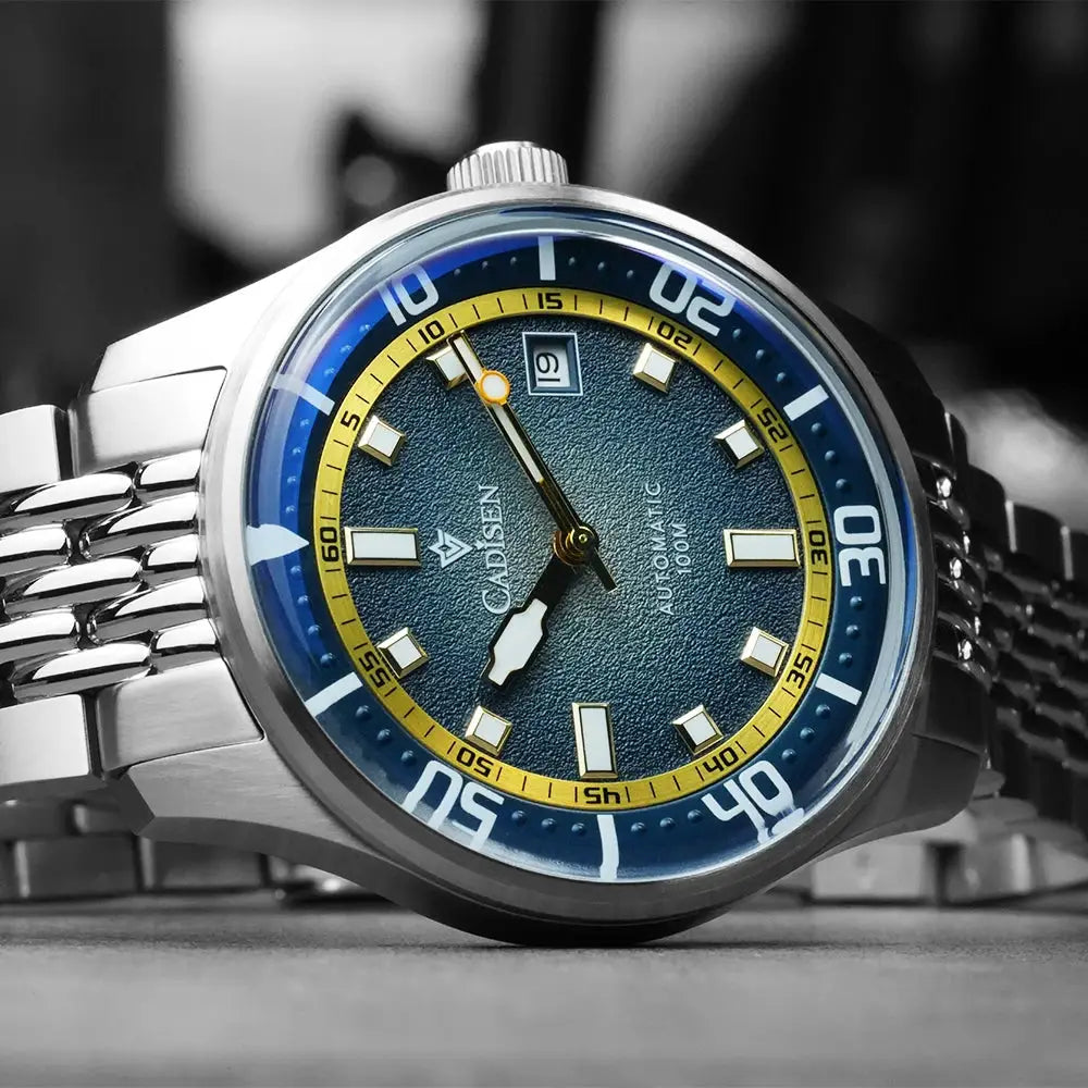 CADISEN automatic watch with silver stainless-steel bracelet, blue dial, yellow ring, and blue bezel