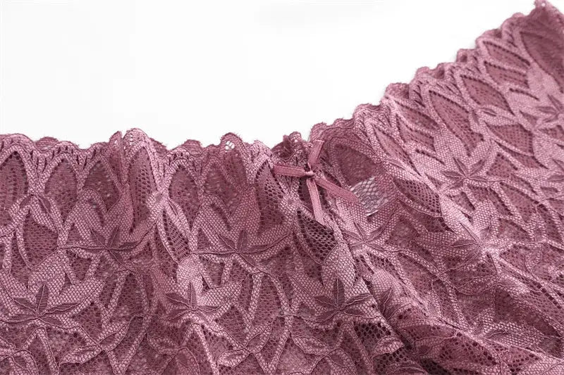 Women’s lavender floral lace panties with bow accent, close-up lace detail.