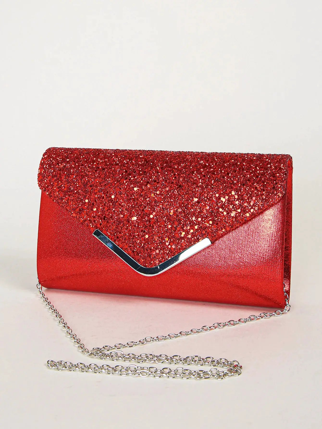 Women’s red sequin envelope clutch bag with silver V-clasp and chain strap