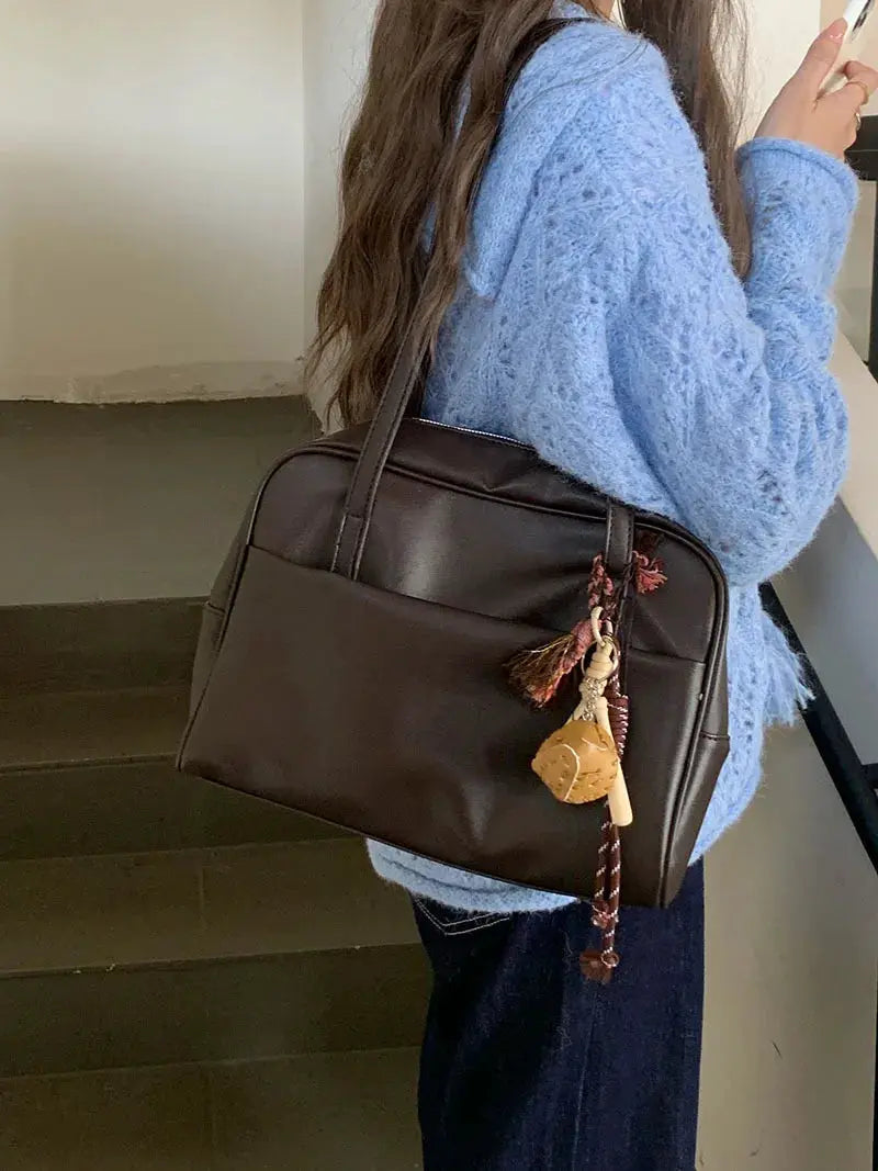 Korean-style large-capacity shoulder tote bag with brown leather-like finish and tassel charm