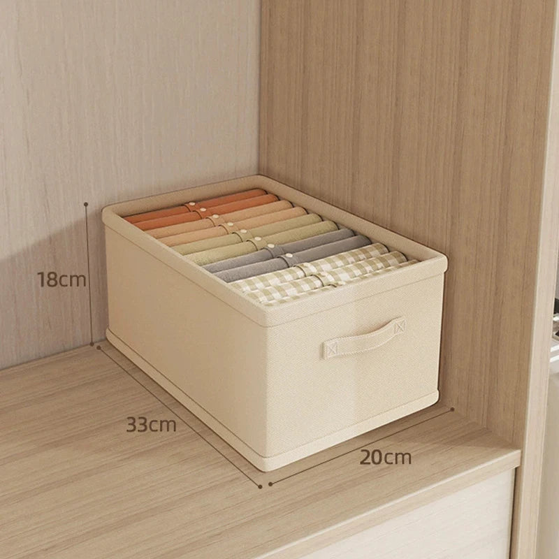 Beige fabric clothes organizer storage box with handle; 18cm tall, 33cm wide, 20cm deep, stores folded garments